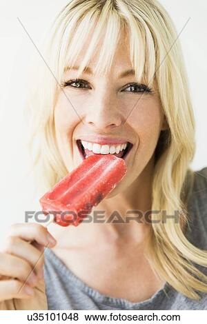 Woman eating ice popsicle View Large Photo Image Stock Photo - Woman eating ice popsicle. Fotosearch