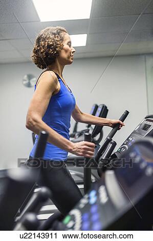 Woman exercising in gym View Large Photo Image Stock Image - Woman exercising in gym. Fotosearch