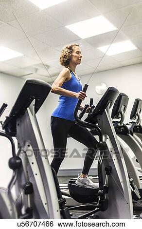 Stock Photograph - Woman exercising in gym. Fotosearch