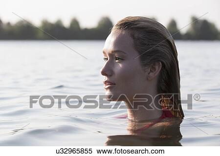 Woman relaxing in lake, Profile View Large Photo Image Stock Photography - Woman relaxing in lake, Profile. Fotosearch