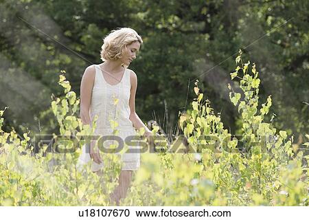 Stock Image - Woman relaxing on meadow. Fotosearch