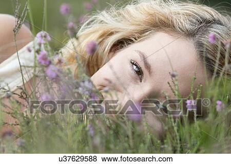 Woman relaxing on meadow View Large Photo Image Stock Photo - Woman relaxing on meadow. Fotosearch