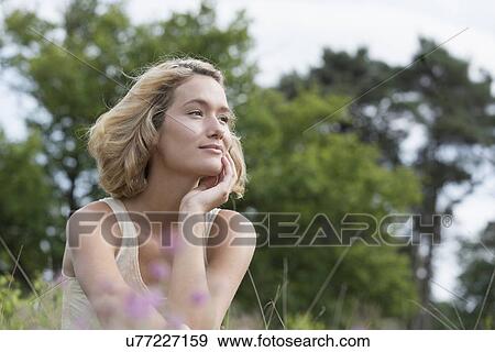 Woman relaxing on meadow View Large Photo Image Stock Photo - Woman relaxing on meadow. Fotosearch