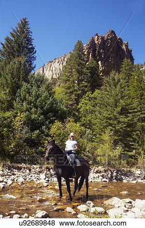 Stock Photo - Woman riding horse. Fotosearch