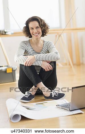 Woman sitting on floor View Large Photo Image Stock Image - Woman sitting on floor. Fotosearch