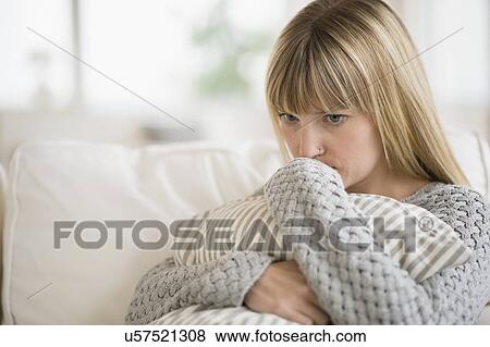 Woman sitting on sofa and thinking View Large Photo Image Stock Photo - Woman sitting on sofa and thinking. Fotosearch
