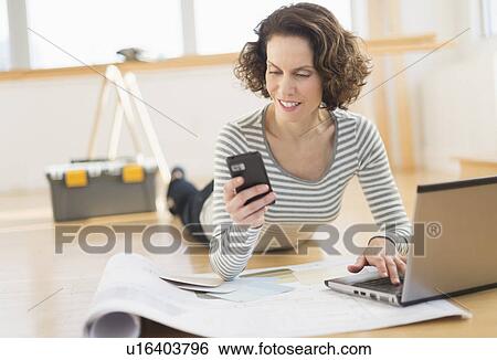 Woman texting and using laptop View Large Photo Image Stock Photograph - Woman texting and using laptop. Fotosearch