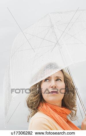 Stock Image - Woman with umbrella. Fotosearch