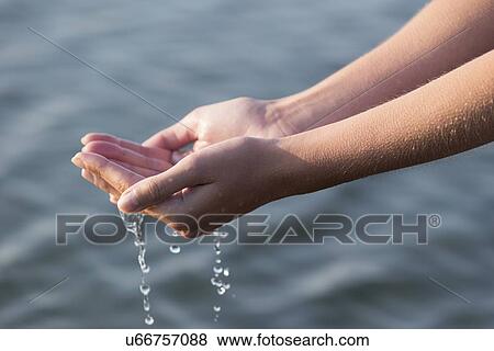 Stock Photo - Woman's hands with waterdrops. Fotosearch