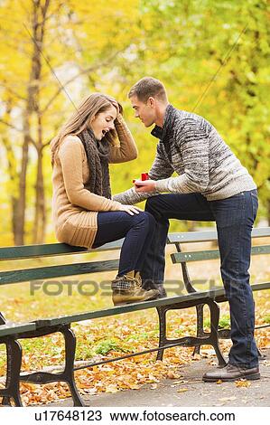 Young man proposing to young woman in Central Park View Large Photo Image Stock Image - Young man proposing to young woman in Central Park. Fotosearch