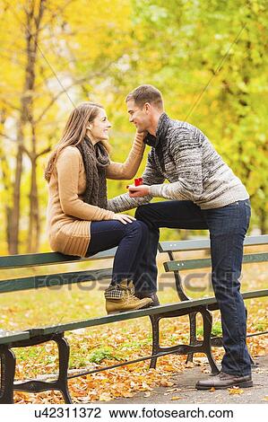 Young man proposing to young woman in Central Park View Large Photo Image Stock Image - Young man proposing to young woman in Central Park. Fotosearch
