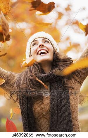 Young woman playing with leaves in Central Park View Large Photo Image Stock Photography - Young woman playing with leaves in Central Park. Fotosearch