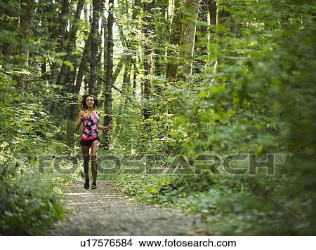 Picture - Young women jogging in forest. Fotosearch