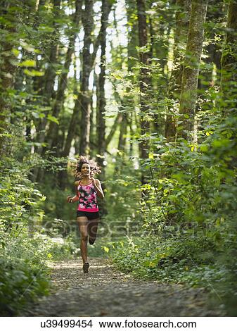 Picture - Young women jogging in forest. Fotosearch