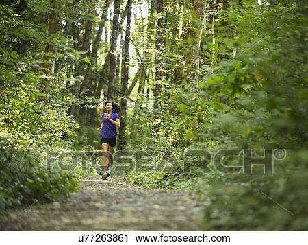 Young women jogging in forest View Large Photo Image Stock Image - Young women jogging in forest. Fotosearch