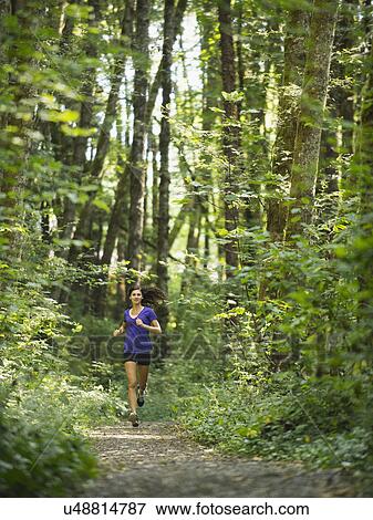 Stock Photo - Young women jogging in forest. Fotosearch