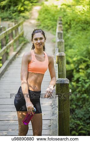 Stock Image - Young women resting after exercising. Fotosearch