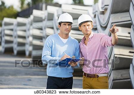 Architects inspecting stock at site View Large Photo Image Stock Image - Architects inspecting stock at site. Fotosearch