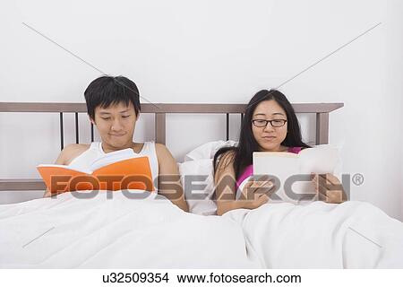 Asian couple reading books in bed View Large Photo Image Picture - Asian couple reading books in bed. Fotosearch