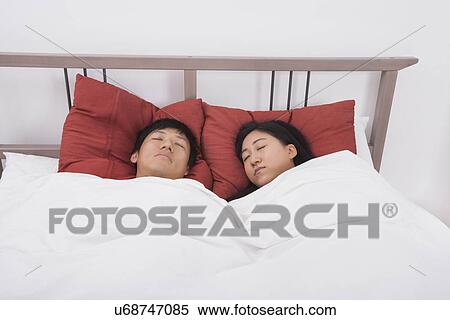 Asian couple sleeping in bed View Large Photo Image Stock Photography - Asian couple sleeping in bed. Fotosearch