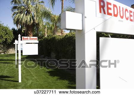Stock Image - "Bank Owned" sign in lawn. Fotosearch
