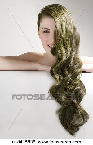 Beautiful woman with long green dyed hair against gray background View Large Photo Image Stock Photography - Beautiful woman with long green dyed hair against gray background. Fotosearch