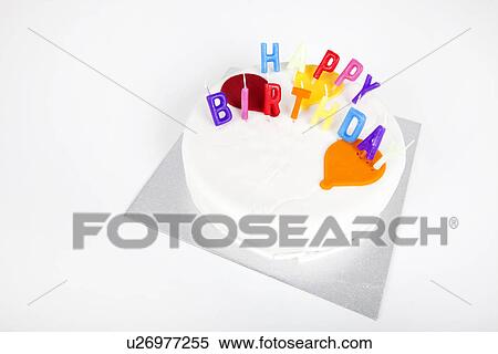 Stock Photography - Birthday cake with candles against white background. Fotosearch
