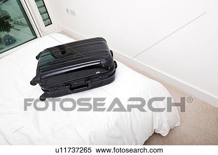 Black suitcase on bed View Large Photo Image Stock Photography - Black suitcase on bed. Fotosearch