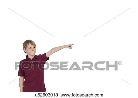 Stock Photo - Boy pointing at copy space on white background. Fotosearch