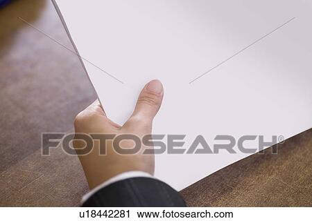 Stock Image - Businessman holds report. Fotosearch