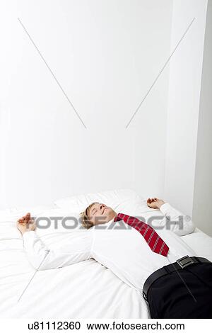Businessman sleeping in bed at home View Large Photo Image Stock Image - Businessman sleeping in bed at home. Fotosearch