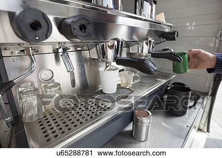 Close-up of coffee machine with hand holding cup View Large Photo Image Stock Image - Close-up of coffee machine with hand holding cup. Fotosearch