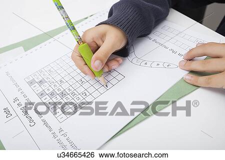 Close-up of girl's hand writing numbers on paper View Large Photo Image Stock Photograph - Close-up of girl's hand writing numbers on paper. Fotosearch