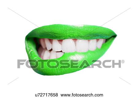 Stock Photo - Close-up of teeth biting green lip over white background. Fotosearch