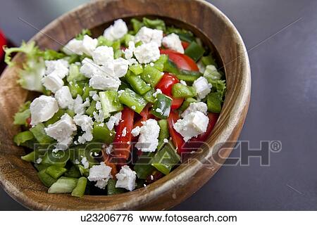 Close-up of vegetable salad in wooden bowl on counter View Large Photo Image Stock Photograph - Close-up of vegetable salad in wooden bowl on counter. Fotosearch