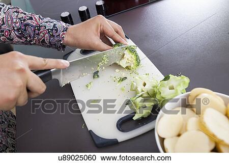 Cropped image of man cutting broccoli at kitchen counter View Large Photo Image Stock Image - Cropped image of man cutting broccoli at kitchen counter. Fotosearch