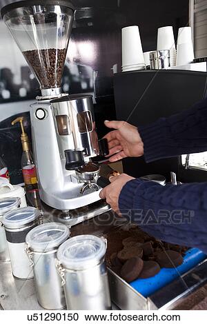 Stock Image - Cropped image of man preparing coffee at mobile coffee shop. Fotosearch