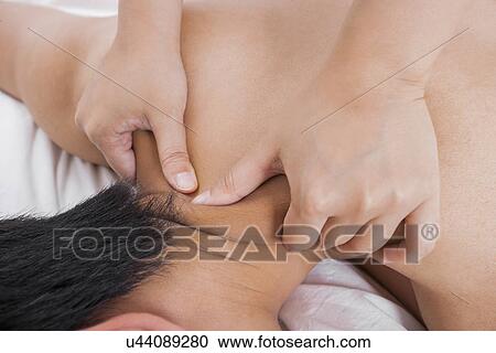 Cropped image of woman massaging man's shoulder in bed View Large Photo Image Stock Image - Cropped image of woman massaging man's shoulder in bed. Fotosearch