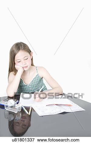 Cute girl studying at table over white background View Large Photo Image Stock Photo - Cute girl studying at table over white background. Fotosearch