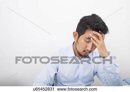 Depressed businessman in office View Large Photo Image Stock Image - Depressed businessman in office. Fotosearch