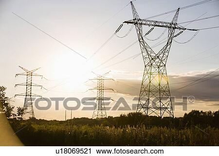 Stock Image - Electric power lines during summer. Fotosearch