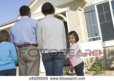 Family with two children (6-8) in front of new house back view View Large Photo Image Stock Photography - Family with two children (6-8) in front of new house back view. Fotosearch
