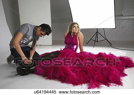 Fashion stylists adjusts model's footwear in studio View Large Photo Image Stock Photography - Fashion stylists adjusts model's footwear in studio. Fotosearch
