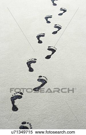 Stock Photography - Footprints on sand at beach. Fotosearch