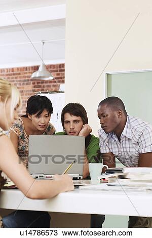 Four people having meeting around laptop. View Large Photo Image Stock Image - Four people having meeting around laptop.. Fotosearch