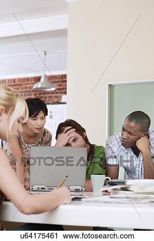 Four people having meeting around laptop. View Large Photo Image Stock Image - Four people having meeting around laptop.. Fotosearch
