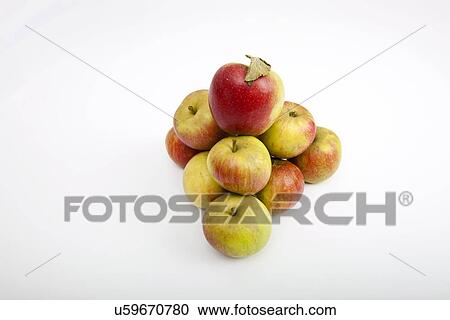 Stock Image - Fresh apples forming pyramid over white background. Fotosearch