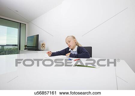 Girl drawing on paper at table View Large Photo Image Stock Image - Girl drawing on paper at table. Fotosearch