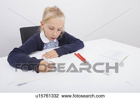 Girl drawing on paper with felt tip pen at table View Large Photo Image Stock Image - Girl drawing on paper with felt tip pen at table. Fotosearch