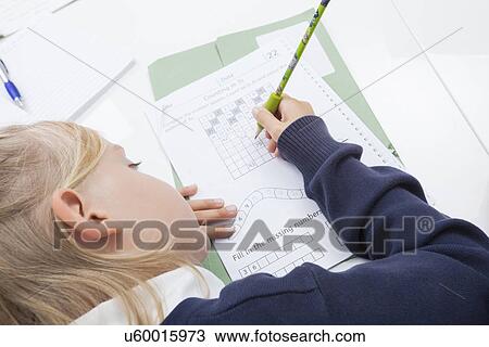 Girl writing numbers on paper at table View Large Photo Image Stock Image - Girl writing numbers on paper at table. Fotosearch